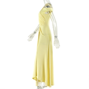 Detail of light yellow ruched dress with off-shoulder design and silky pleated texture