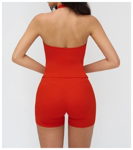 Rear view of vibrant red halter yoga vest and high-waist shorts set showing V-shaped back