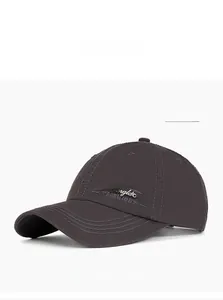Detail of dark grey cotton baseball cap with The Angle Fashion metallic logo embroidery