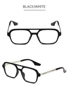 Detail of vintage aviator sunglasses featuring a black double-bridge frame and metal temples