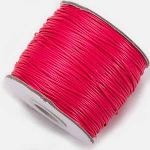 Close-up of rose red Korean waxed polyester cord spool for DIY jewelry making