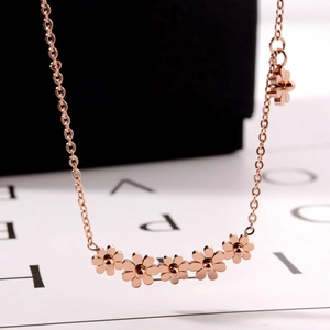 Rose gold daisy necklace for women featuring five connected floral charms on a fine chain