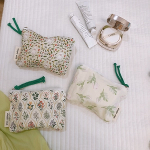 Three-piece floral cotton zipper pouches with green rope pullers and nature prints