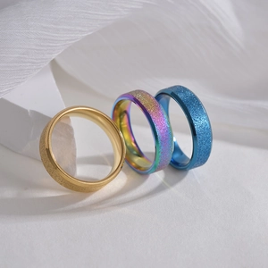 Stack of gold, rainbow and blue 6mm frosted finish stainless steel rings for women