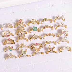 Selection of gold-plated butterfly and flower rings with pearls and colorful zircons
