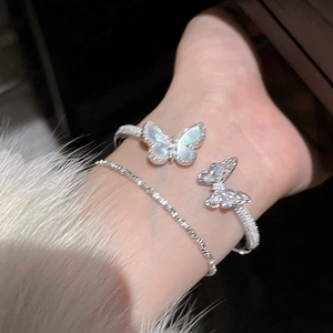 Detail view of silver butterfly bangle set with sparkling zircons and mother of pearl inlay