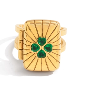 Macro detail of square locket ring with green clover pattern on gold stainless steel
