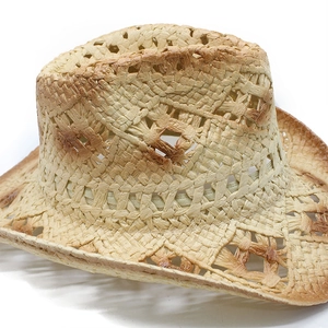 Detailed macro view of hollow weave texture and burnt edge on summer straw cowboy hat