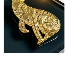 Macro shot of leopard brooch detail showing intricate golden grid and curved textures