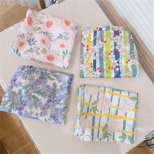 Detailed top view of four different floral and striped printed cotton fabric tote bags