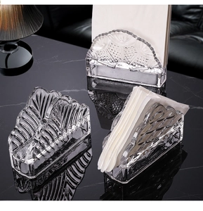 Detailed view of crystal glass napkin holder with elegant embossed textures on marble surface