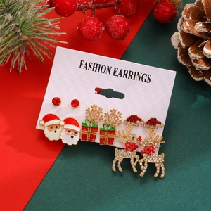 Detailed view of Christmas earring set with Santa, snowflake, and reindeer on card