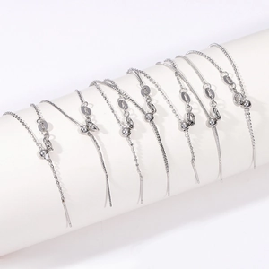 Detail of assorted adjustable stainless steel chain necklaces with slider beads and needles