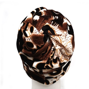 Close-up of leopard print neck warmer with plush lining and pleated top design