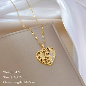 Detail of gold hollow heart necklace with Guadalupe relief and sparkling zircon inlay