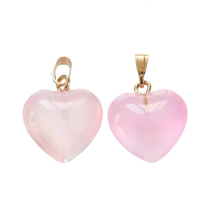 Detail of pink acrylic heart pendants with gold metal hooks for DIY jewelry making