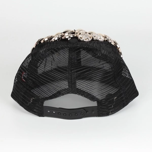 Detail of black mesh trucker hat with silver rhinestone accents and adjustable strap