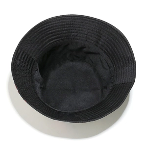 Detail of cotton sun hat brim stitching and fried egg pattern on black canvas material