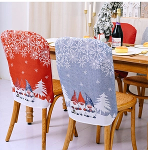Detail of Christmas chair covers with gnome and snowflake patterns on a dining chair