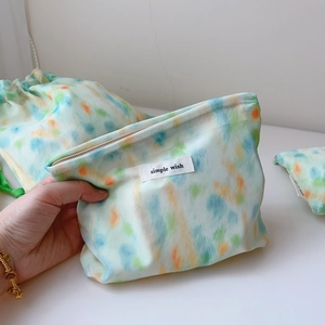 Close-up of mint green watercolor chiffon cotton pouches with Simple Wish logo label