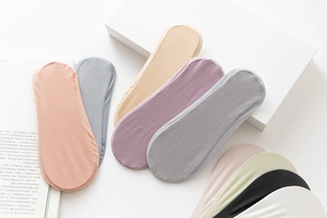 Flat lay of colorful no-show socks in soft cotton fabric displayed on a clean background
