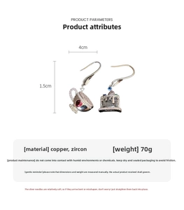 Detail view of asymmetric gold-plated coffee cup and cake earrings with zircon inlay