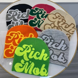 Winter knit beanies with Rich Mob embroidery in six different colors on marble background