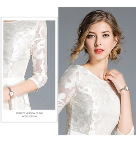 Detailed view of white floral hollow lace embroidery on elegant half-sleeve dress