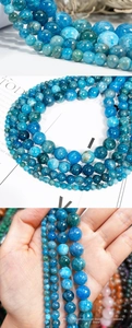 Macro view of multi-size natural blue apatite round beads showing crystal texture