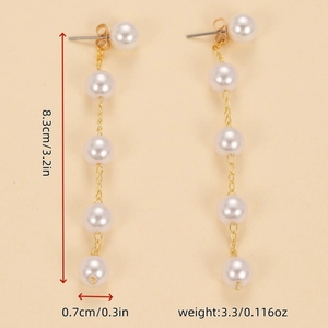 Detail view of gold chain pearl drop earrings with 8.3cm length and 3.3g weight specs