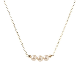 Detail of three white freshwater pearls on a delicate 14K gold-filled necklace chain