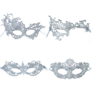Detail of four silver glitter masquerade masks with intricate bohemian lace patterns