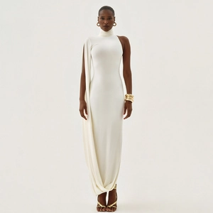 Detail of elegant white mock neck dress with asymmetric cape sleeve and waist cut