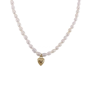 Elegant natural freshwater pearl necklace featuring a polished golden heart-shaped pendant