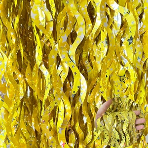 Detail of gold foil curtain with wavy texture and star patterns for party decoration