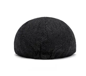 Detailed back view of a grey herringbone newsboy cap featuring classic British tweed fabric