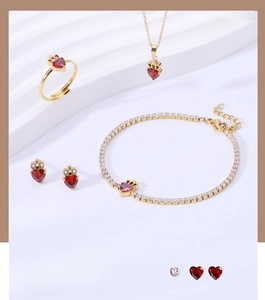 Detail view of heart-shaped red zircon crown jewelry set including necklace and bracelet