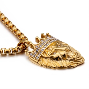 Gold stainless steel lion head pendant necklace with crowned rhinestones on white background