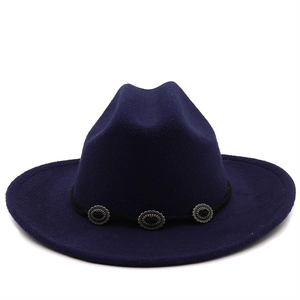 Detailed view of navy blue wool fedora hat with silver engraved buckle accents