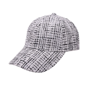 Detail of black and white tweed baseball cap with a classic textured houndstooth weave