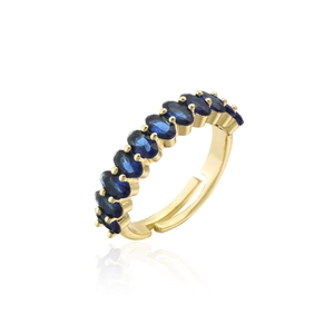 Detail of gold plated adjustable ring featuring oval blue cubic zirconia gemstones