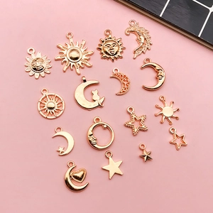 Detail of celestial alloy charms including sun, moon, and star shapes for DIY jewelry