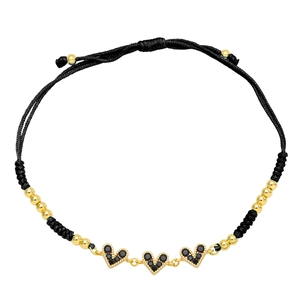 Detail of adjustable black woven bracelet with three black zircon heart pendants and gold beads