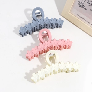 Three elegant 13cm flower hair claws in blue, pink and beige for stylish updos
