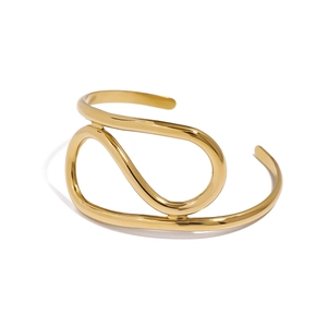 Gold stainless steel geometric open bracelet with elegant minimalist crisscross design