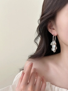 Silver petal tassel earrings shown on model with elegant geometric sequin layers