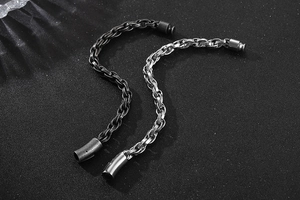 Detail of vintage steel bracelets in black and silver finishes with magnetic clasp