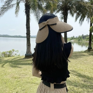 Women's straw top sun visor hat with large brim and black bow for outdoor beach activities