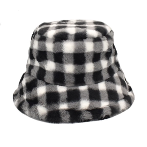 Close-up of soft black and white checkerboard faux fur bucket hat with warm texture