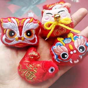 Handheld collection of plush Chinese zodiac charms featuring lion dance and lucky cat